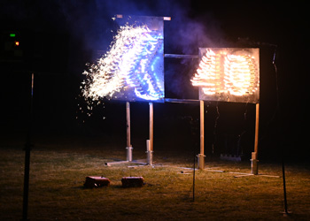 Fireworks in the shape of the numbers '40' glow in the darkness, as part of an outdoor anniversary celebration.